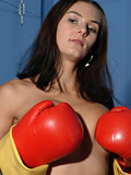 Horny girl Gianna with red boxing gloves plays with her big tits and a black strapon sex toy - 1